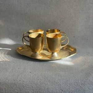 Vintage set of four brass mugs with brass tray